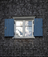 window with shutters of old farmhouse.