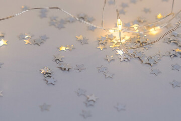 Silver stars confetti on a white background. Festive background