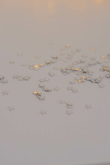 Silver stars confetti on a white background. Festive background