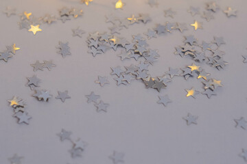 Silver stars confetti on a white background. Festive background