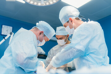 Doctors surgeons perform an operation in a hospital