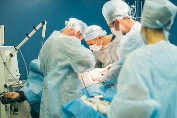 Team of surgeons doing operation in hospital
