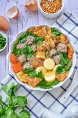 Thai omelet soup with bean curd and minced pork with vermicelli and vegetables ,top view food table, white bowl, home cooked 