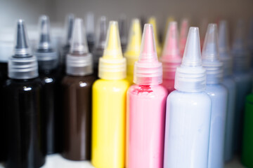 Bottles of art paints of various colors were lined up in large numbers