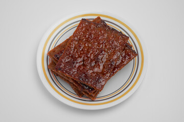 Pork jerky known as 'Bak Kwa' in Chinese, served on a plate