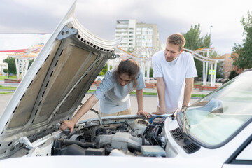 Car Troubles: Two Men Inspecting Engine Under Hood on Highway
