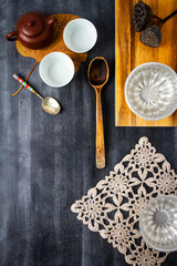 Various antique objects on black chalkboard background