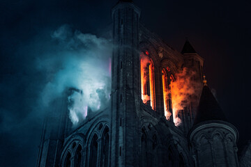 Burning church in Ghent lightfestival, blue and orange flames, dramatic 