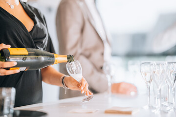 bartender pouring champagne in glasses © Loic