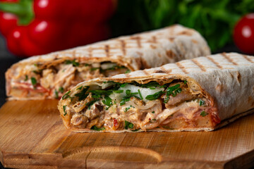 greek  meat gyros with tzatziki sauce on black background.