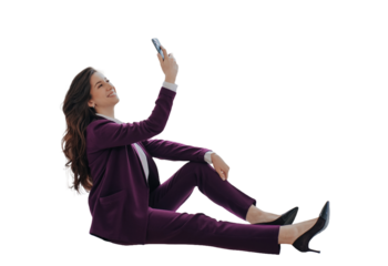 Successful businesswoman in violet suit sitting against transparent background holding phone, talking via video call. Gorgeous smiley lawyer happy to completed the case. Cheerful teacher at break