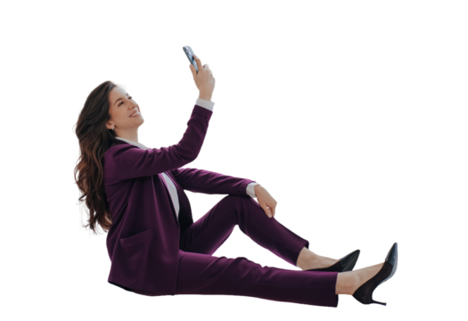 Successful businesswoman in violet suit sitting against transparent background holding phone, talking via video call. Gorgeous smiley lawyer happy to completed the case. Cheerful teacher at break
