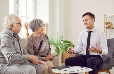 Senior pair and young consultant talking, giving expert advice, help, elder consulting service,...