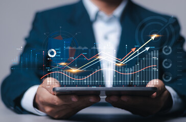 Digital online marketing, Financial and investment business planning and development. Businessman analyzing growth sales data graph on virtual screen. - obrazy, fototapety, plakaty