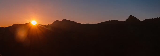 Alpine summer sunrise with a sunstar at Mount Sechszeiger, Jerzens, Imst, Tyrol, Austria