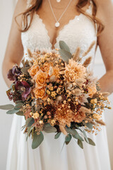 bride in white dress holding her bridal bouquet