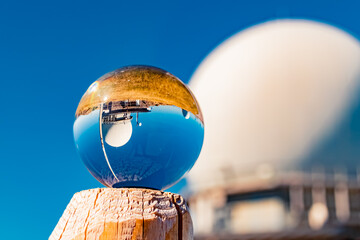 Crystal ball landscape shot with a radar antenna dome at Mount Arber, King of the Bavarian Forest,...