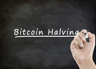 Bitcoin Halving concept with handwriting on blackboard