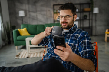 Adult man use mobile phone smartphone at home browse internet or send text messages sms texting