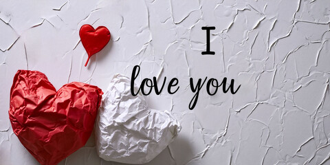 Valentines day Banner with red and white papper hearts on white background and text I love you. Copy space