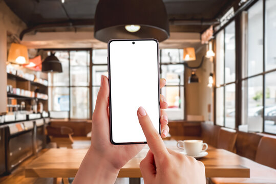 Smartphone mockup in a coffee shop, capturing the essence of a productive morning. Ideal for showcasing the work on mobile concept in a trendy cafe setting