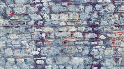 Stone Wall Pattern. Aged Worn Vintage Fence. Ancient Texture. Grunge background Toned Photo