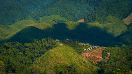 Green mountain view with a small village on the hill
