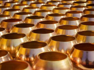 Golden round containers arranged in a pattern.