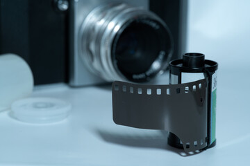 Film roll in front of an analog SLR camera from the 1950s