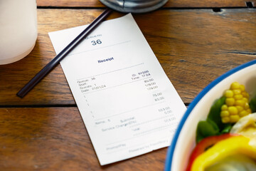 Closeup food receipt with part of salad and a cup of coffee on the wood table
