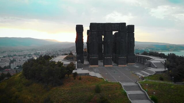 Aerial view of Monument History of Georgia, North of Tbilisi. Dramatic gray weather, overcast sky. Day time.