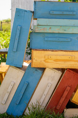 Pieces of bee hives stacked in a pile
