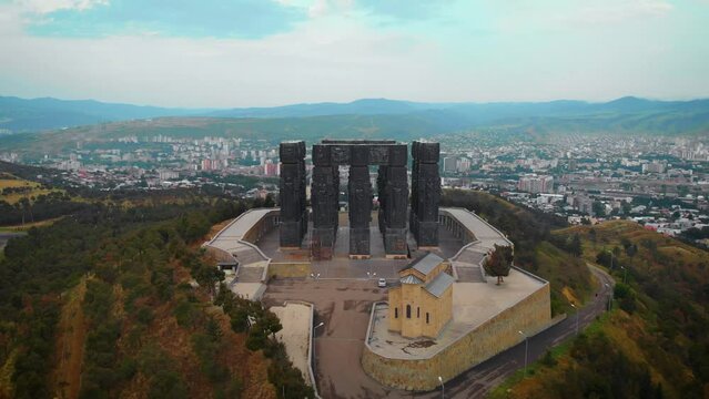 Aerial view of Monument History of Georgia, North of Tbilisi. Dramatic gray weather, overcast sky. Day time.