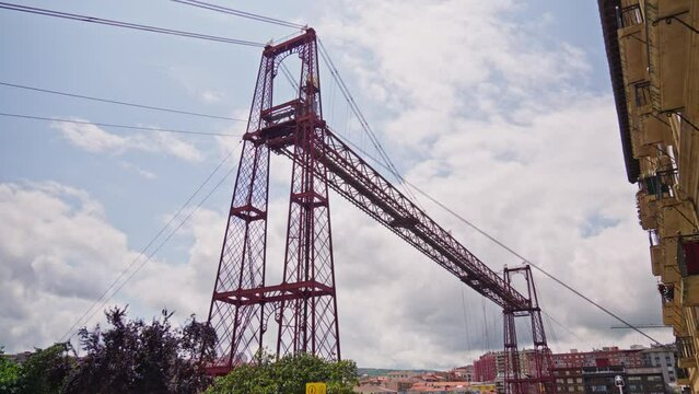 A towering crane stands adjacent to a high-rise building