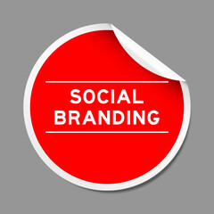 Red color peel sticker label with word social branding on gray background