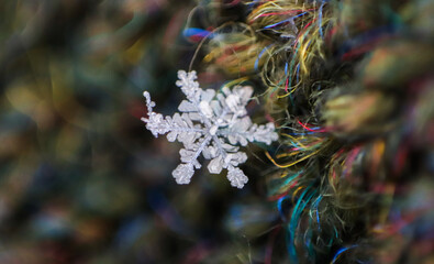 The snowflake sparkles on fabric