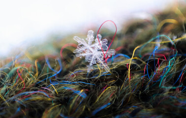 The snowflake sparkles on fabric