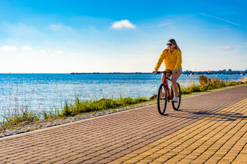 Woman riding bike at seaside
