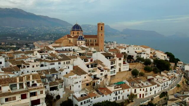 Spain Altea white old town aerial 4K, blue dome Church of Our Lady of Consolation and mountains, Costa Blanca cinematic drone Mediterranean village scenery
