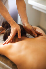 Fototapeta premium Masseur rubbing shoulders of woman