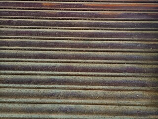 Security roller shutter door by stanless steel blue color of industrial factory building for entrance to storage in warehouse with stripes style textured background.