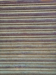 Security roller shutter door by stanless steel blue color of industrial factory building for entrance to storage in warehouse with stripes style textured background.