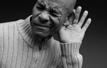 deafness suffering from hearing loss on grey black background with people stock image stock photo	