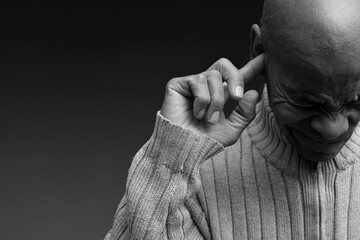 deafness suffering from hearing loss on grey black background with people stock image stock photo	