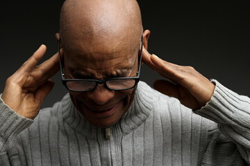 deafness suffering from hearing loss on grey black background with people stock image stock photo	