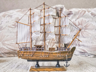 Model of a sailing ship on a beige background