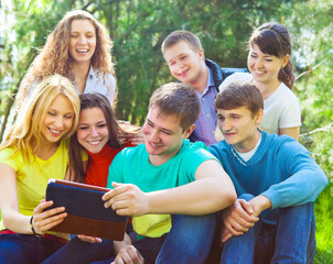 Fototapeta na wymiar Students using tablet computer while doing homework