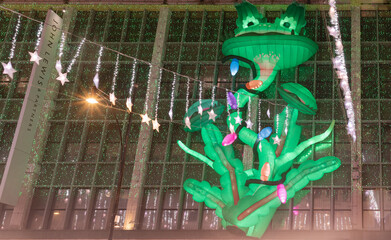 Frog Christmas decoration led lights display. Look up view of the Christmas decoration lights display in front of the john lewis & partners department store. Space for text, Selective focus.