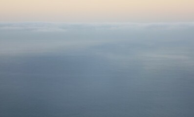 Obraz premium misty morning with low clouds over the sea