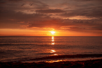 Beautiful view of the sea sunset. Orange evening sky.